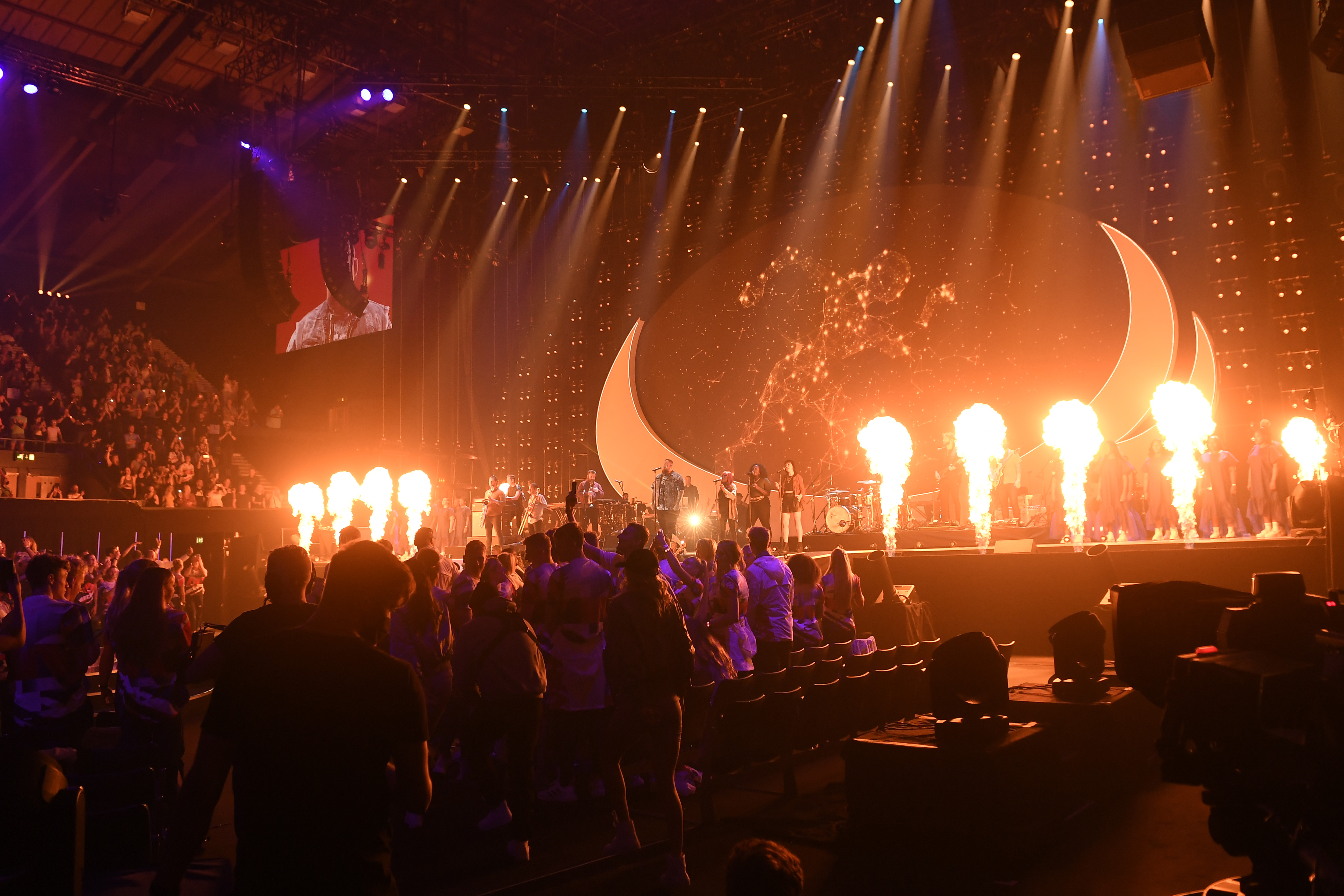 A large crowd enjoying the concert with pyrotechnics, at the national lottery homecoming event at AO arena