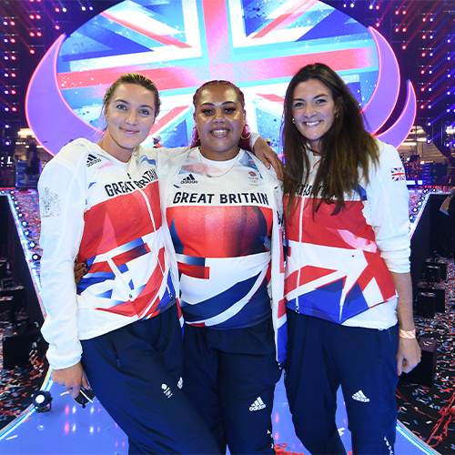 Three women posing for a picture at the national lottery homecoming event at AO arena.